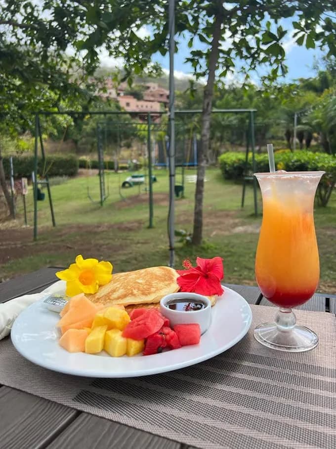 Breakfast plate with fresh fruit and a juice