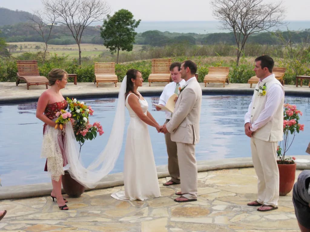 A couple exchanging vows by the resort pool