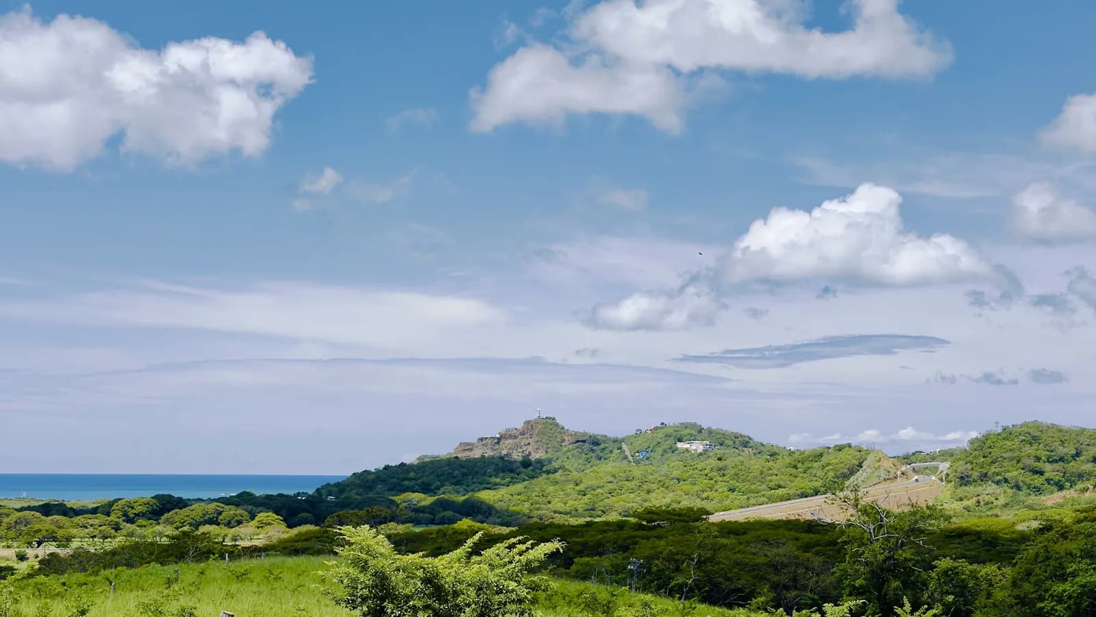 Green hills around San Juan del Sur under a blue sky