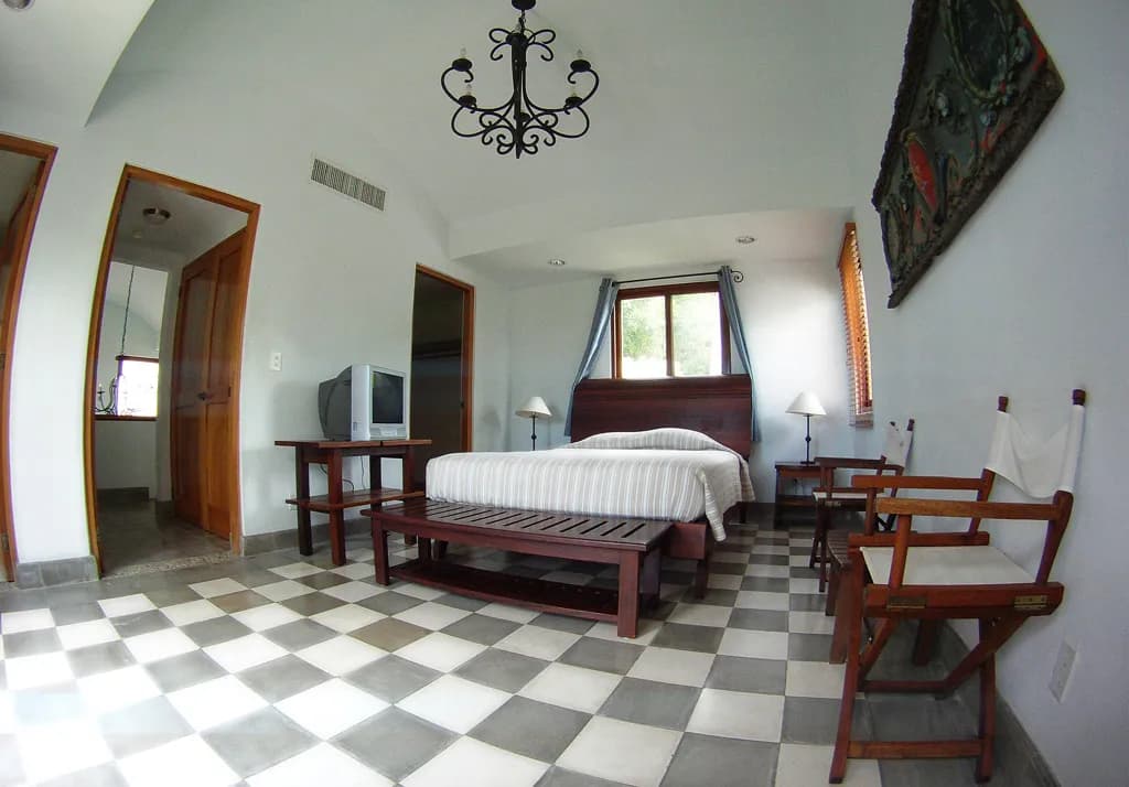 Villa bedroom with a queen bed and hardwood furniture