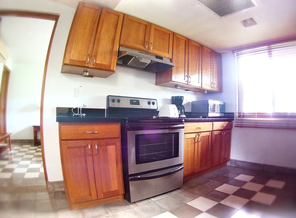 Villa kitchen with wood cabinets and stainless-steel appliances